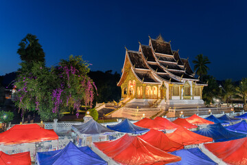 Generated Night market in Luang Prabang with the royal palace of Luang Prabang also known as Luang...