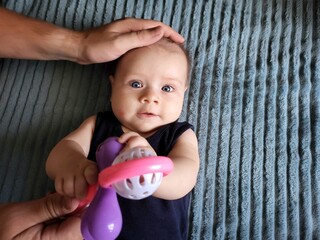 A Father Gives A Rattle To A Child