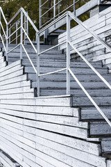 Fototapeta premium fragment of an old wooden staircase, without people. wooden steps of an old staircase. wooden staircase with railings. Vertical photo