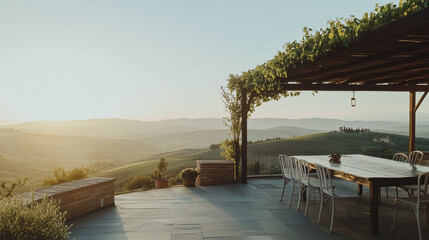 A wide-angle shot of an open-air terrace with a green pergola, offering a view of rolling hills, captured during early morning