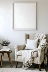Fototapeta premium A blank white frame hanging above a corner armchair, surrounded by a throw blanket and a small side table. 