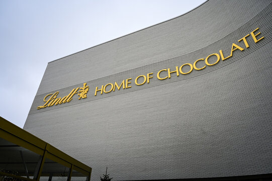 Zurich, Switzerland - 10 16 2024: Building facade with the golden lettering of the Lindt Home of Chocolate Museum building in Switzerland.