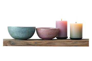 PNG of candles placed on a shelf alongside a bowl and plate against transparent background
