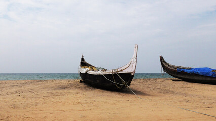 Fishing boats moored on the beach at Kovalam, Thiruvananthapuram, Kerala, India