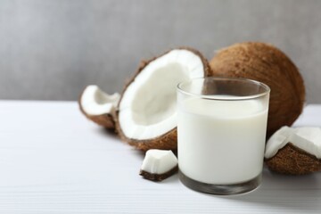 Glass of coconut milk on wooden background 