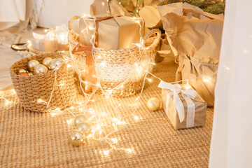 Christmas decorations in woven baskets with glowing fairy lights.