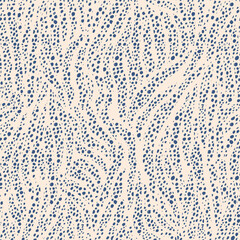 Abstract pattern with irregular blue dots on a light beige background, creating a flowing, dynamic texture. The design evokes a sense of movement and organic forms in nature.