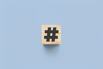 # (hashtag) wooden cube on blue background