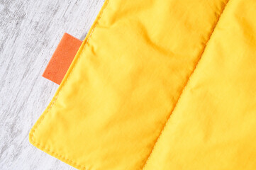 Close up of yellow pet friendly waterproof and windproof breathable fabric with orange label, ideal