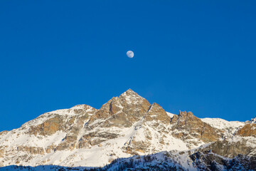 panorama of the mountains whit moon and blue sky 