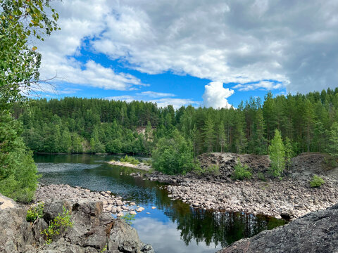 A vast expanse of water beautifully encircled by trees and rocks