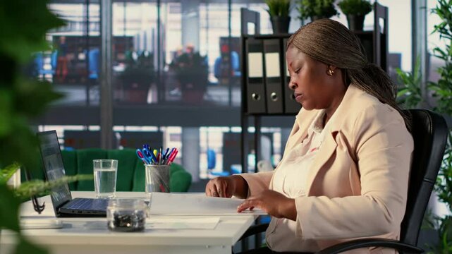 General director signing work contracts and approving employees requests, doing daily paperwork tasks for productivity. Black CEO gives authorization for leave request or license agreement. Camera A.