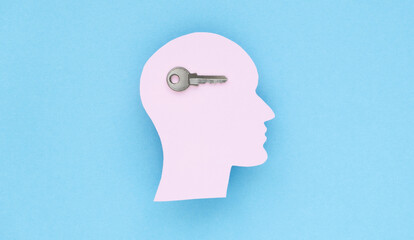 The concept of unlocking your potential. Figurine of a man's head with a key, concept for the discovery of new talents and achievements