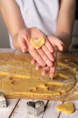 Baking heart-shaped cookies with homemade dough in a cozy kitchen setting