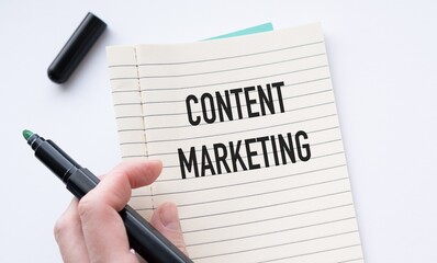 Obraz premium Person writing with black marker on notebook. Business concept for content marketing.