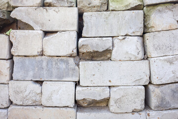 Weathered stone wall texture. Irregular blocks, showing age and damage. Great for background or design.
