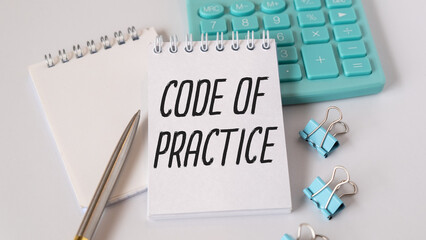 CODE OF PRACTICE text on the paper sheet with chart, color paper and calculator