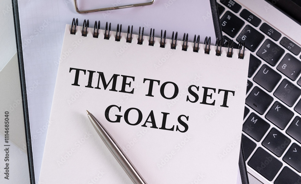 Poster time to set goals text written on a notebook on grey background with chart and keyboard , business c