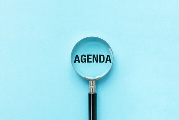 Magnifier focuses on the word agenda. Concept of plans, appointments and to do list, Business Concept