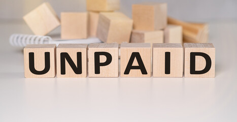 UNPAID word written on wood block. UNPAID text on wooden table for your desing