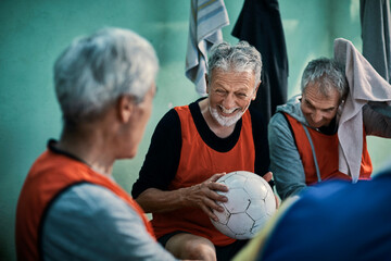Senior men getting ready in the locker room to go out and play soccer