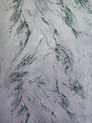 The textured background is white and green. Green plaster with mother of pearl