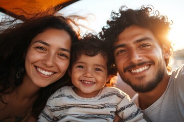 Fototapeta premium A joyful family poses for a picture under a colorful sky at sunset, capturing the love, unity, and happiness shared among them in a serene outdoor setting.