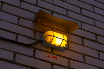 the lamp on the brick wall of the house