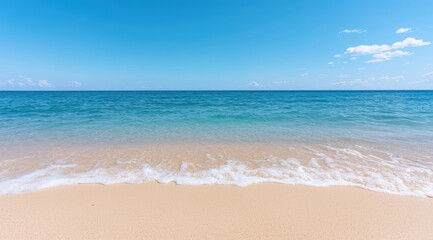 Fototapeta premium Serene beach scene with clear blue sky and turquoise waters