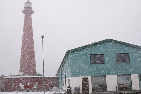 Heavy snow and Red Lighthouse in Andenes, in Lofoten in Norway, traveling around the Baltic sea