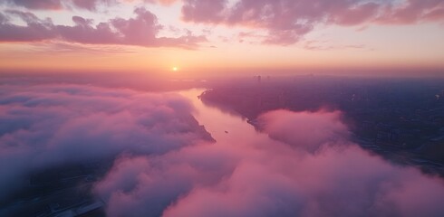 Obraz premium Serene sunset over a city shrouded in pink clouds. A breathtaking view of nature's artistry.