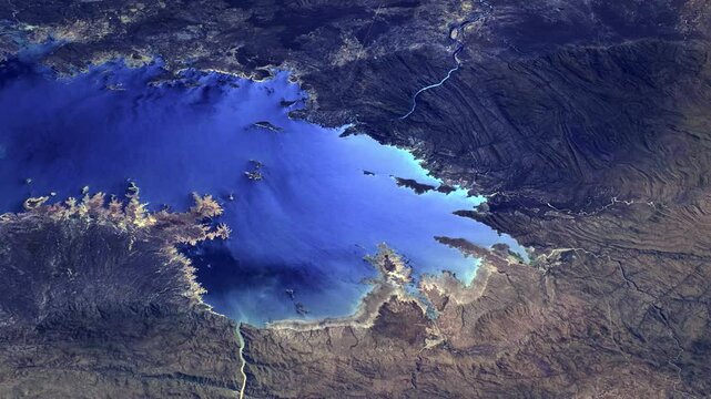 Flying over lake reservoir and mountains, sunrise animation, satellite view of lake Kariba, Africa. Based on images furnished by Nasa