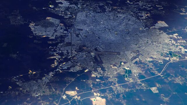 Sunrise animation flying over city satellite aerial view of Merida, Mexico. Based on images furnished by Nasa