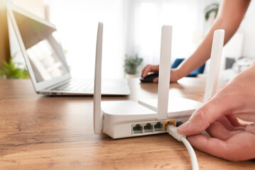 Modern wi-fi router on light table in room