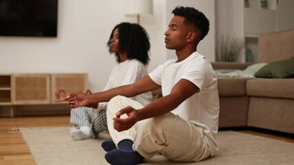 Black Couple Meditating at Home for Relaxation and Mindfulness