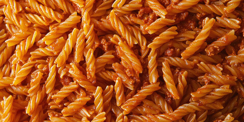 Close-up of spirali pasta topped with rich Bolognese sauce, showcasing minced meat and tomato flavors, perfect for a hearty Italian meal.