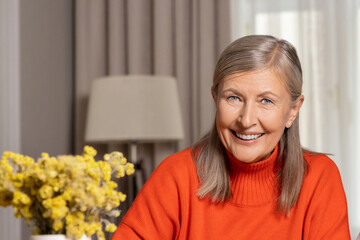 Waist up of a smiling mature woman at home