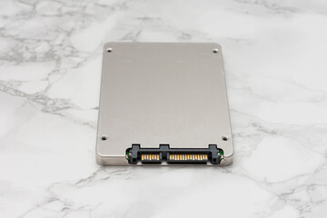 Silver computer hard drive sits on a marble countertop