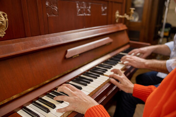 Close up picture of two people at the piano