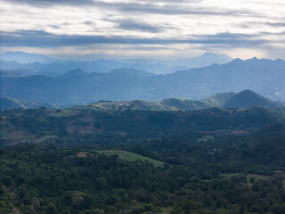 Stunning landscape view of layered mountains and lush forests in early morning