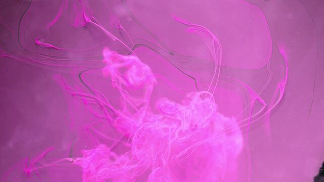Abstract background.Pink ink crashes in water.