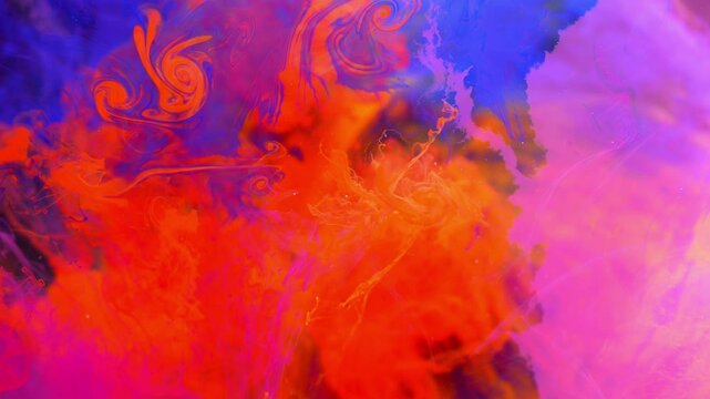 Abstract inks in shades of blue and red blend together.