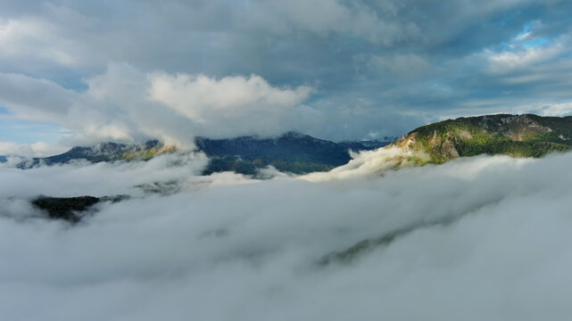 Aerial view of clouds and mountains at sunrise
