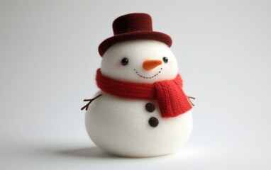 Fototapeta premium Snowman Plush Toy A soft and fluffy snowman plush toy with a red scarf, a tiny carrot-shaped nose, and a felt top hat, sitting on a clean white background.