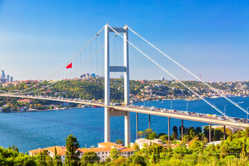 Fototapeta premium Istanbul Bosphorus Bridge or 15th July Martyrs Bridge with Istanbul panorama cityscape during summer sunny day. Istanbul, Turkiye.