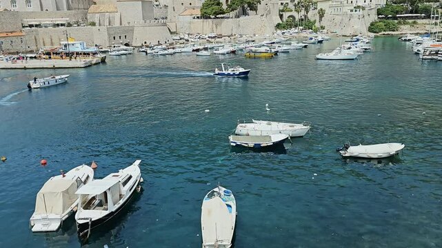 DUBROVNIK, CROATIA - MAY 18, 2024: Boats motoring in harbor at Dubrovnik, Croatia