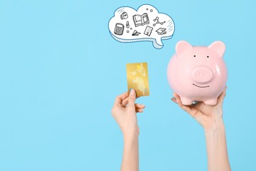 Hands with credit card and piggy bank on light blue background. Tuition fees concept