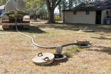 Septic tank maintenance. Vacuum truck pumping septic tank