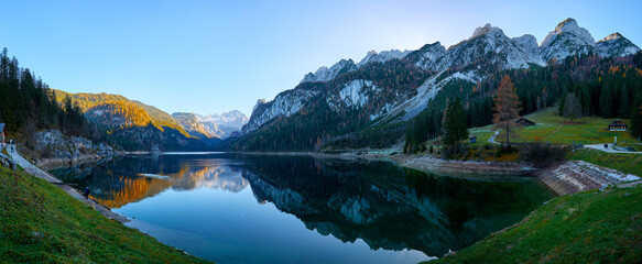 Beautiful Gosausee lake landscape with Dachstein mountains, forest, clouds and reflections in the water in Austrian Alps. Salzkammergut region