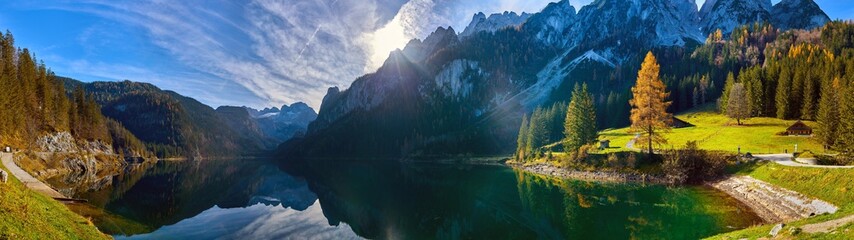 Beautiful Gosausee lake landscape with Dachstein mountains, forest, clouds and reflections in the water in Austrian Alps. Salzkammergut region